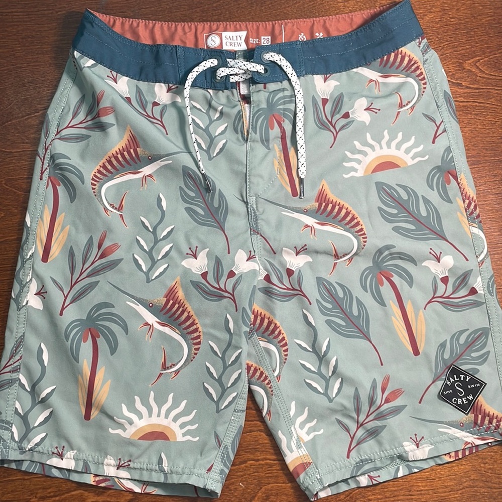Salty Crew swim trunks size 28”, but logo on shorts is messed up.